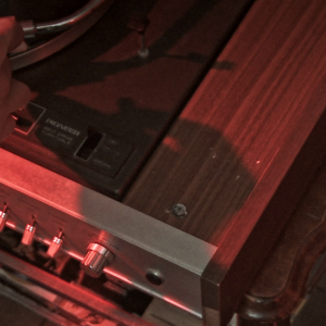 Still from the film Nowhere Place. It is a close-up of a the corner of a record player.