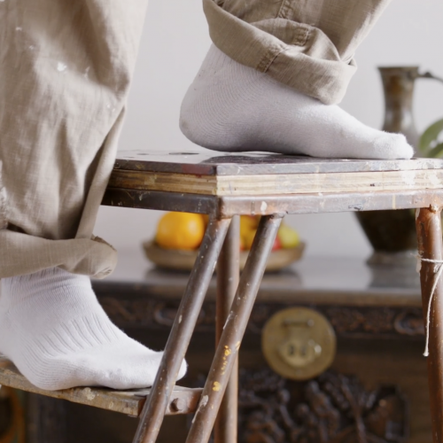 Still from the commercial Papa. It's a close up of feet on a stepladder.