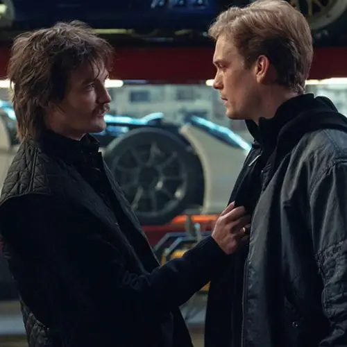Still from Safe Harbor. Marco and Farrell are facing each other in a car garage.